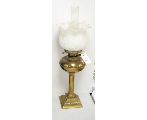 Brass Corinthian column oil lamp, with brass reservoir, white glass shade moulded with flowers and scrolls, 61cms high includ