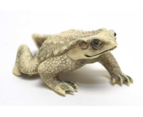 Japanese netsuke, formed as a toad, with black character marks to underside, 44mm wide.