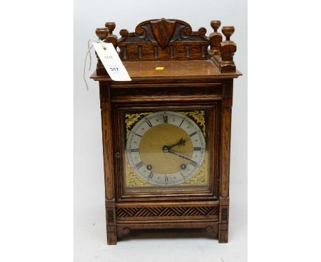 An early 20th Century oak mantel clock, in architectural case, 36cms high.