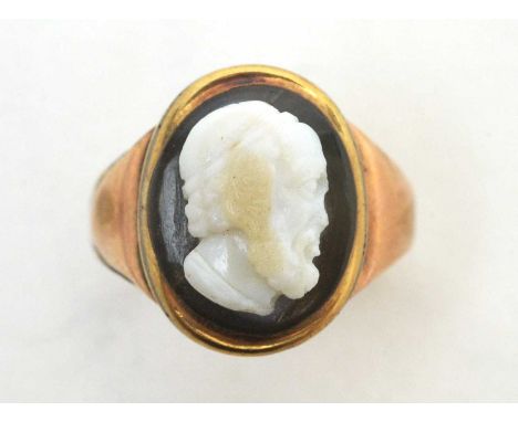 A 19th Century carved stone cameo ring, the classical male bust carved in banded agate with highlights to the hair, in yellow