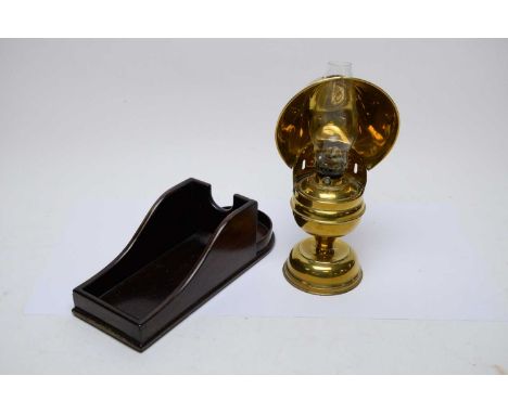 Ship's brass oil lamp with brass reservoir and brass shade, 29cms high; and a mahogany wine bottle holder (2). 