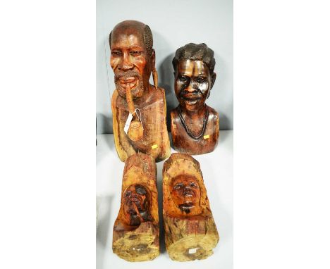 African carved wood bust of a man, modelled smoking a pipe, 53cms high; along with an African carved wood bust of a lady and 