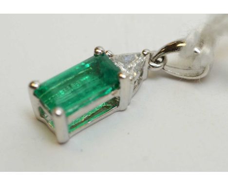 Emerald and diamond pendant, the rectangular step cut emerald set below trilliant cut diamond, in 18ct white gold mount. 