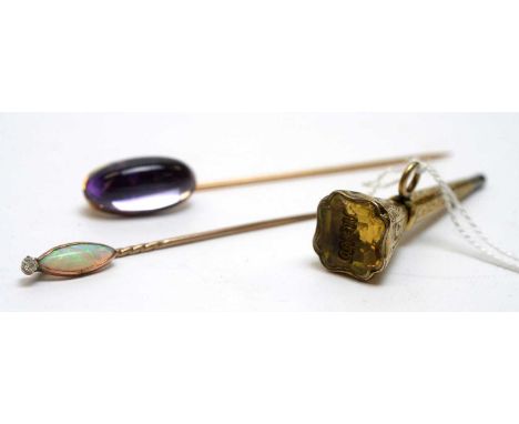 Two tie/stick pins, one set with opal and white stone, the over oval amethyst cabochon; together with a yellow metal 19th Cen