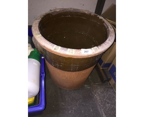 A large terracotta planter with handles and glazed exterior 