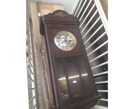 A wall clock and an artificial Christmas tree 
