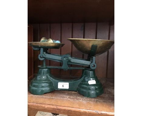A set of enameled scales with brass trays and weights 