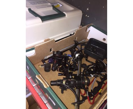 A box of fishing reels and rod rests alongside a fishing box with contents 
