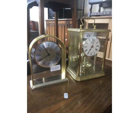 A Hermle revolving pendulum quartz mantle clock and an Ellis &amp; Lloyd quartz mantle clock 