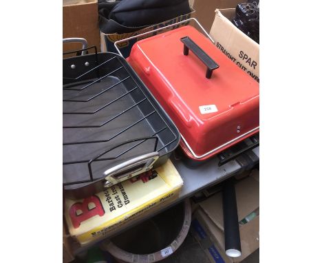 A gas barbecue with lid, a cast iron convertible barbecue and a cooking pan. 