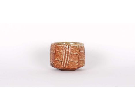 Phil Rogers (British 1951-2020) Stoneware Chawan Circa 2008, faceted body with reddish brown shino glaze, impressed mark to b