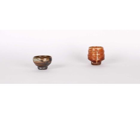 Phil Rogers (British 1951-2020) Two Stoneware Sake Cups (Guinomi) The taller with ridged body and red shino glaze, the smalle