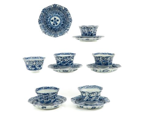 Depicting flowers in garden, including Kangxi mark, saucers are 14 cm. in diameter, chip and hairline.