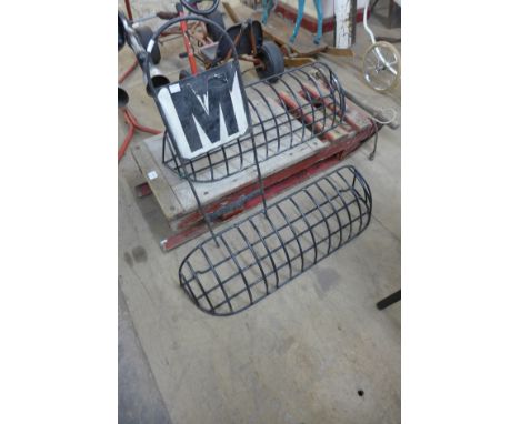 A vintage wooden sledge, two hay racks and an equestrian sign