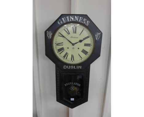 A 19th Century American Regulator A wall clock, bearing Guinness. Dublin inscription to case
