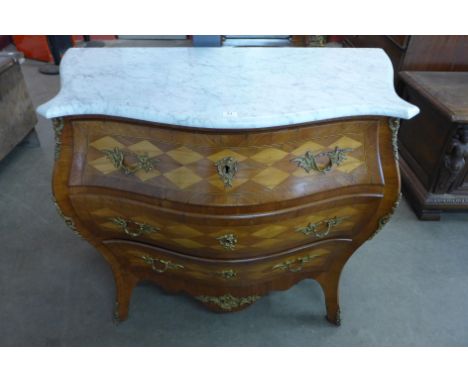A French Louis XV style walnut parquetry inlaid bombe shaped commode, with white marble top