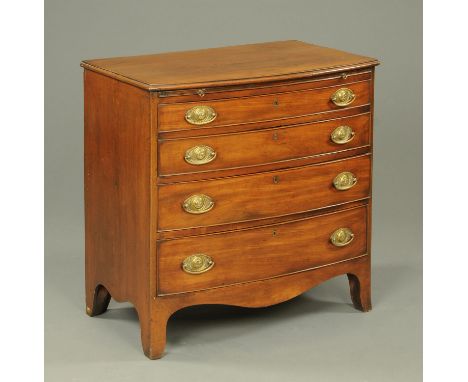 A George III mahogany bowfronted chest of four long graduated drawers with brass drop handles with oval backplates and raised