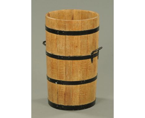 An oak barrel form stick stand, with metal bindings and two carrying handles.  Diameter 36 cm, height 61 cm.  