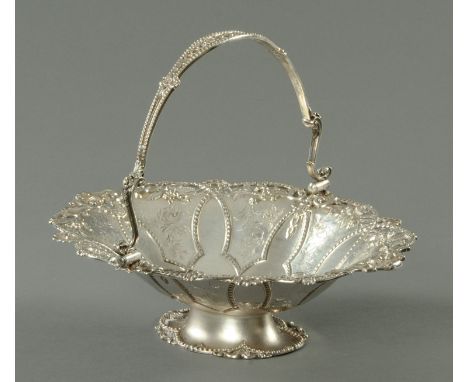 A large Victorian silver plated fruit basket, late 19th century, engraved with foliate scroll and with pierced rim with leave