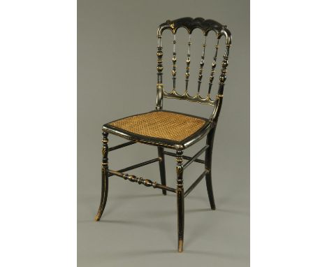 A late 19th century ebonised musical chair, with Bergere seat and musical movement playing two airs, paper label beneath seat