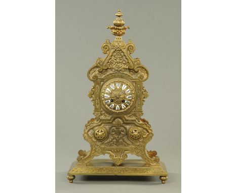 A 19th century French brass mantle clock, with porcelain Roman numerals and two-train striking movement.  Height 56 cm. 