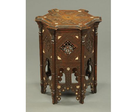 An Islamic hardwood hexagonal occasional table, inlaid with bone.  Width +/- 50 cm, height 63 cm.    CONDITION REPORT:  The t