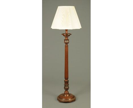 A mahogany torchere lamp standard, 20th century, with reeded column with carved foliate terminals on a circular base raised o