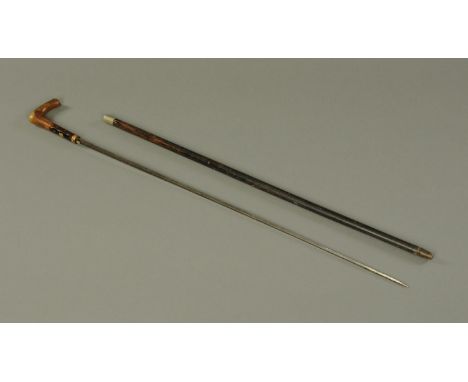 A sword stick, 19th century, with horn handle, the lower part being dark stained and inset with a vacant medallion surrounded