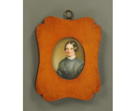 A half length portrait miniature on porcelain panel, mid 19th century, young lady, mounted in a burr maple frame, the reverse