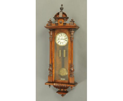 A Victorian walnut twin weight regulator wall clock, with two-train striking movement.  Height 134 cm (see illustration).   C