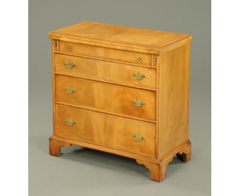 A walnut bachelors chest, second half 20th century, with turnover top with moulded edge and reentrant corners, four frieze dr