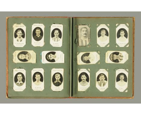 An early 20th century cigarette card album, containing cards to include black and white prominent footballers, Taddy & Co., I