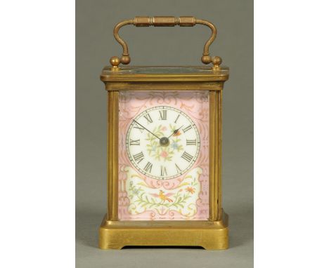 An Edwardian brass carriage clock, with pompadour pink porcelain panels, timepiece only.  Height excluding carrying handle 11