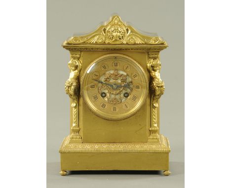 A Victorian brass mantle clock, circa 1890, architectural form, the pediment with Medusa mask and classical scrolls, the gilt