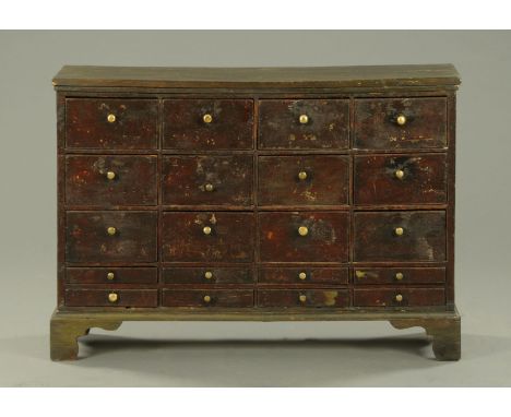 A 19th century painted pine flight of drawers, raised on bracket feet.  Width 115 cm (see illustration). 