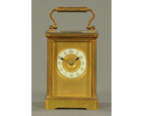 An Edwardian brass carriage clock, Mappin & Webb, with two-train striking movement.  Height excluding carrying handle 12 cm. 
