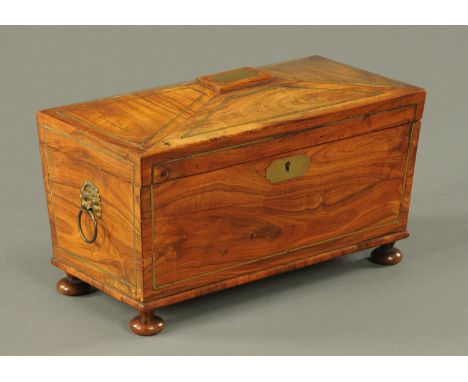 A Regency kingwood brass strung tea caddy, sarcophagus form, leather lined and with two interior compartments and glass bowl,