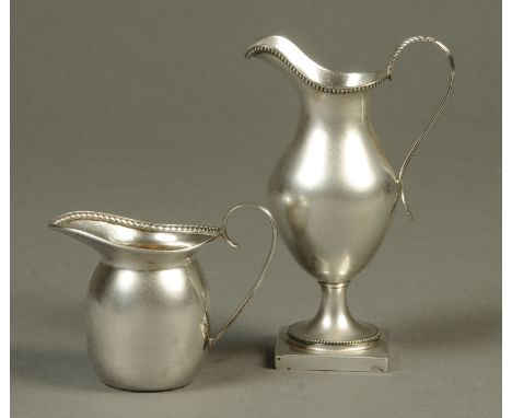 Two silver cream jugs, one of helmet form with beaded border, Mappin & Webb, London 1905, the other Deykin & Harrison, Birmin