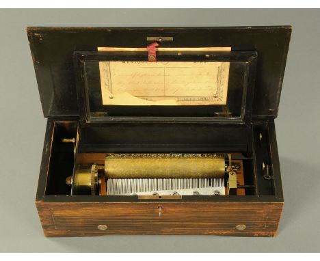 A Swiss music box, 19th century, playing six airs, in rosewood and ebonised box with inlaid decoration.  Drum 20.9 cm.    CON
