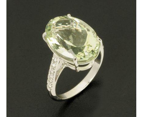 An 18 ct white gold green amethyst and diamond ring, amethyst 11 carats, diamonds .24 carats, size O.