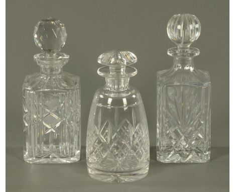 Two cut glass spirit decanters, and a cylindrical decanter.  