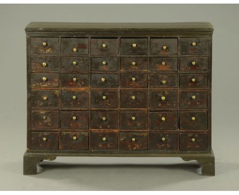 A 19th century painted pine flight of drawers, each drawer with brass handle and all raised on bracket feet.  Width 115 cm (s