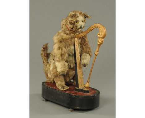 A 19th century musical automaton, in the form of a cat playing a harp, with clockwork movement and internal cylinder, raised 