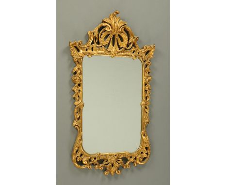 A Chippendale style gilt framed mirror, 20th century, the frame formed of pierced C scrolls and flowers.  Height 87 cm, width