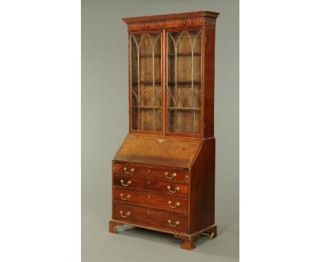 A George III mahogany bureau bookcase, with moulded dentil cornice above a pair of glazed doors, the base with crossbanded sl