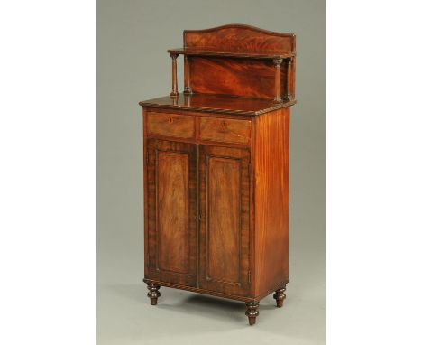 A small Regency mahogany chiffonier, with rear shelved upstand, two drawers and pair of doors and raised on short turned legs