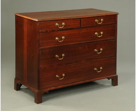 A George III mahogany chest of drawers, with two short and three long graduated drawers with brass swans neck drop handles an