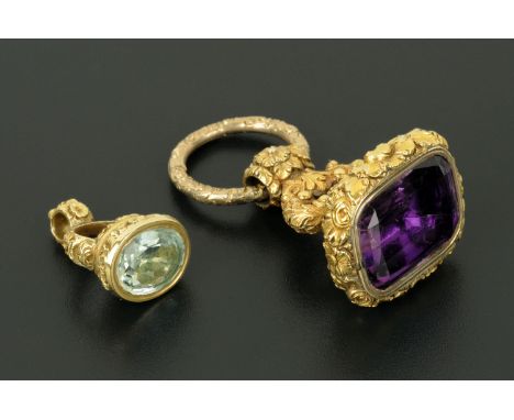 A large Victorian gilt metal fob seal, set with amethyst glass all on a foliate decorated suspension ring, height 5.5 cm, wid