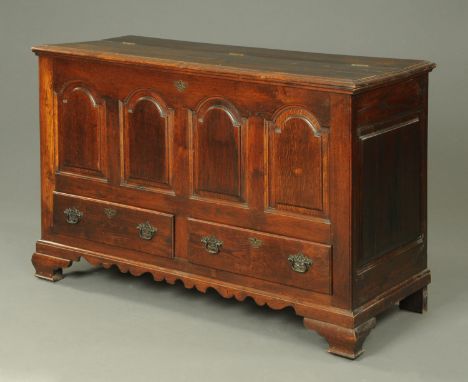 A 19th century oak mule chest, with lift up top and four panelled front above two drawers with brass drop handles and raised 