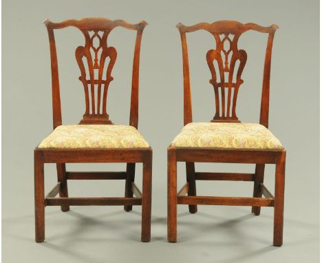 A pair of George III mahogany Chippendale style side chairs, with pierced splat backs, drop in seats and raised on moulded ch